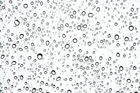 Fresh water drops on the glass as background